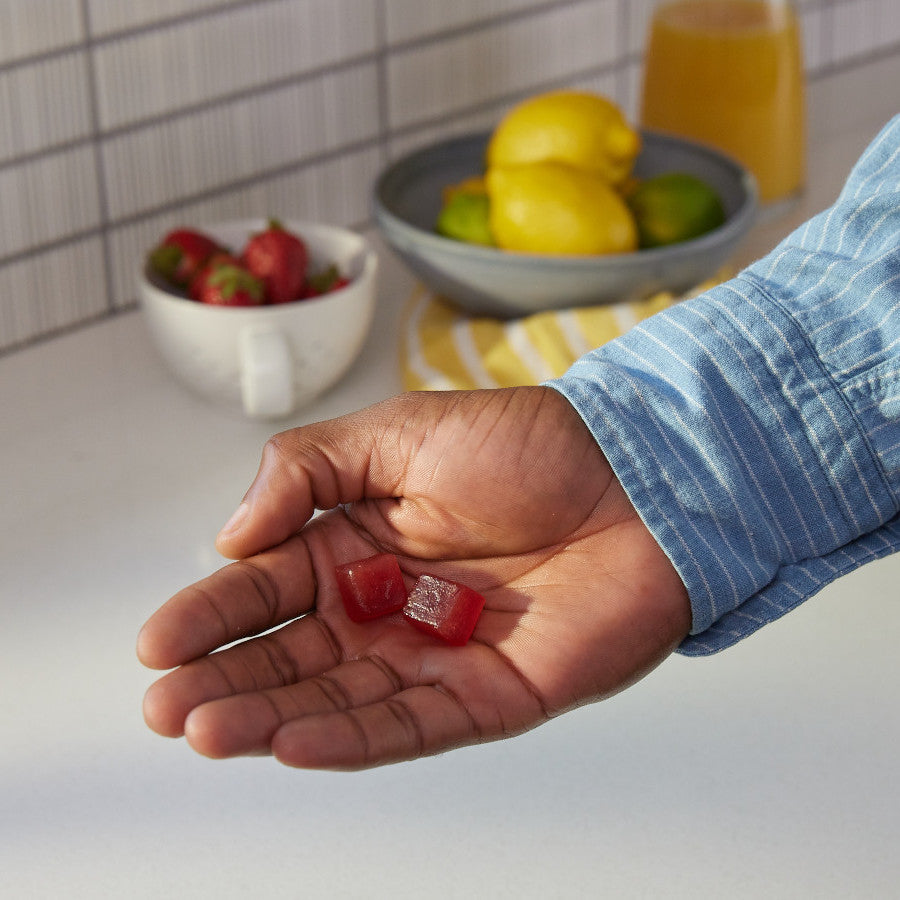 a hand holding haroutine liposomal vitamin c gummies